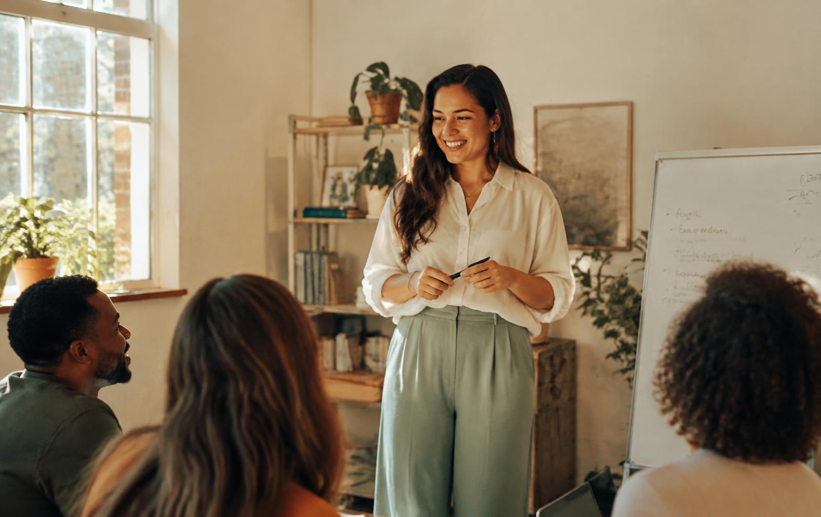 A founder presenting confidently to her engaged team